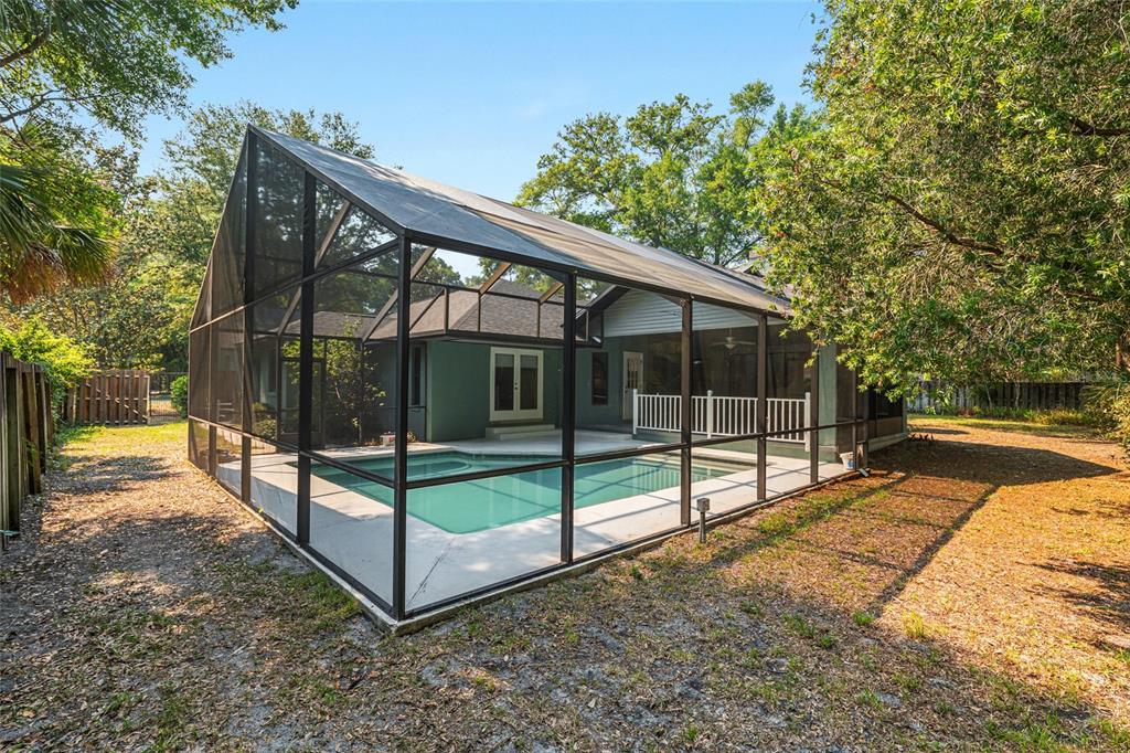 2023 Southwest 76 Terrace Gainesville, FL 32607 - Photo 69 of 95 a view of backyard with large trees and wooden fence