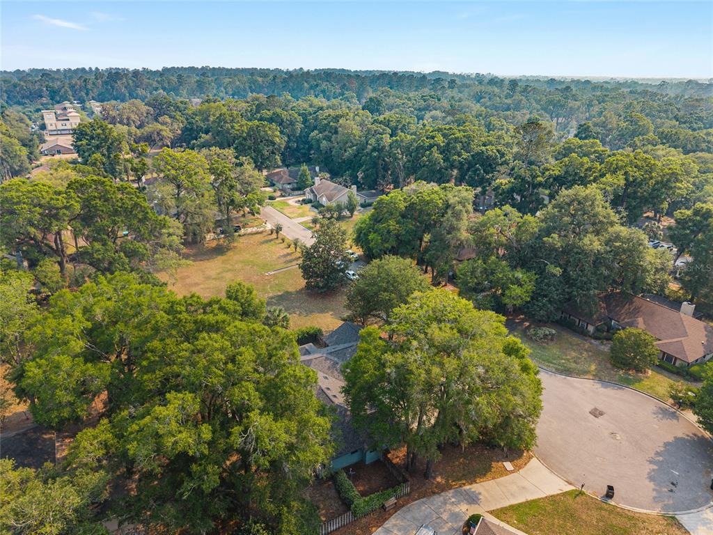 2023 Southwest 76 Terrace Gainesville, FL 32607 - Photo 85 of 95 an aerial view of residential house with outdoor space and trees all around