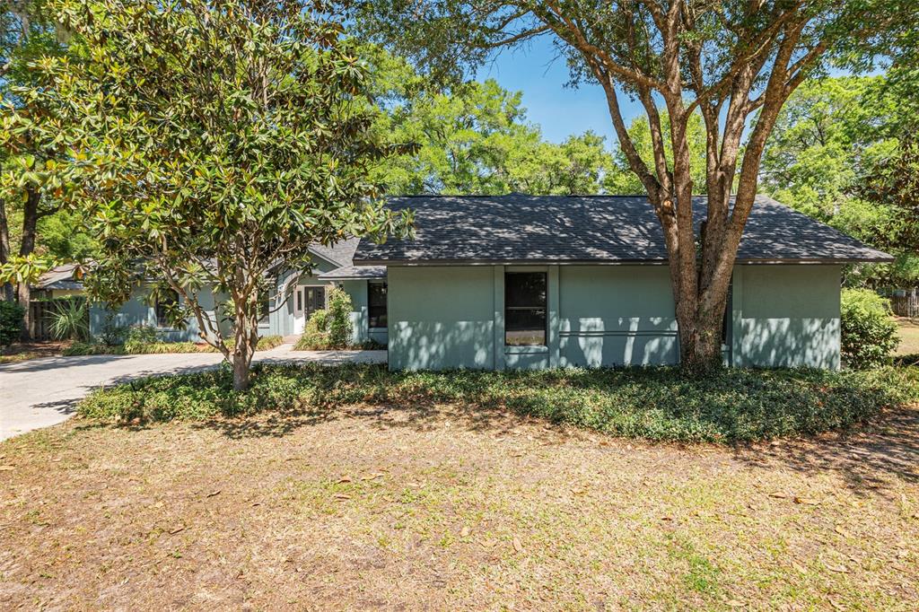 2023 Southwest 76 Terrace Gainesville, FL 32607 - Photo 89 of 95 a view of a house with a tree in the yard