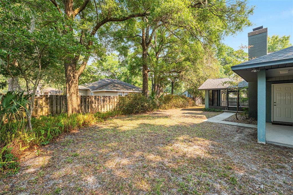 2023 Southwest 76 Terrace Gainesville, FL 32607 - Photo 92 of 95 a front view of a house with a yard and tree s