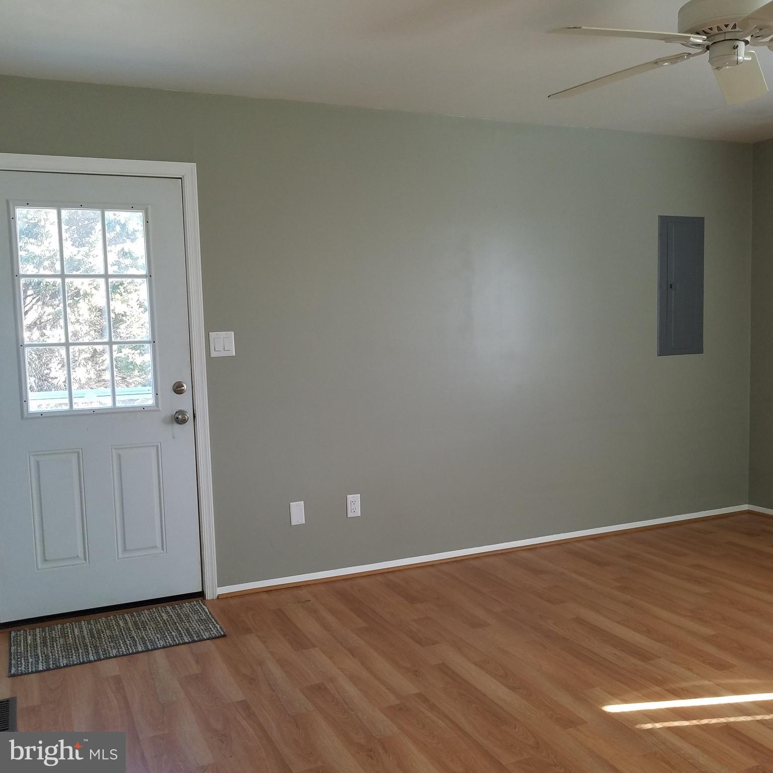 5460 Bethlehem Road Preston, MD 21655 - Photo 2 of 25 a view of an empty room with wooden floor and a window