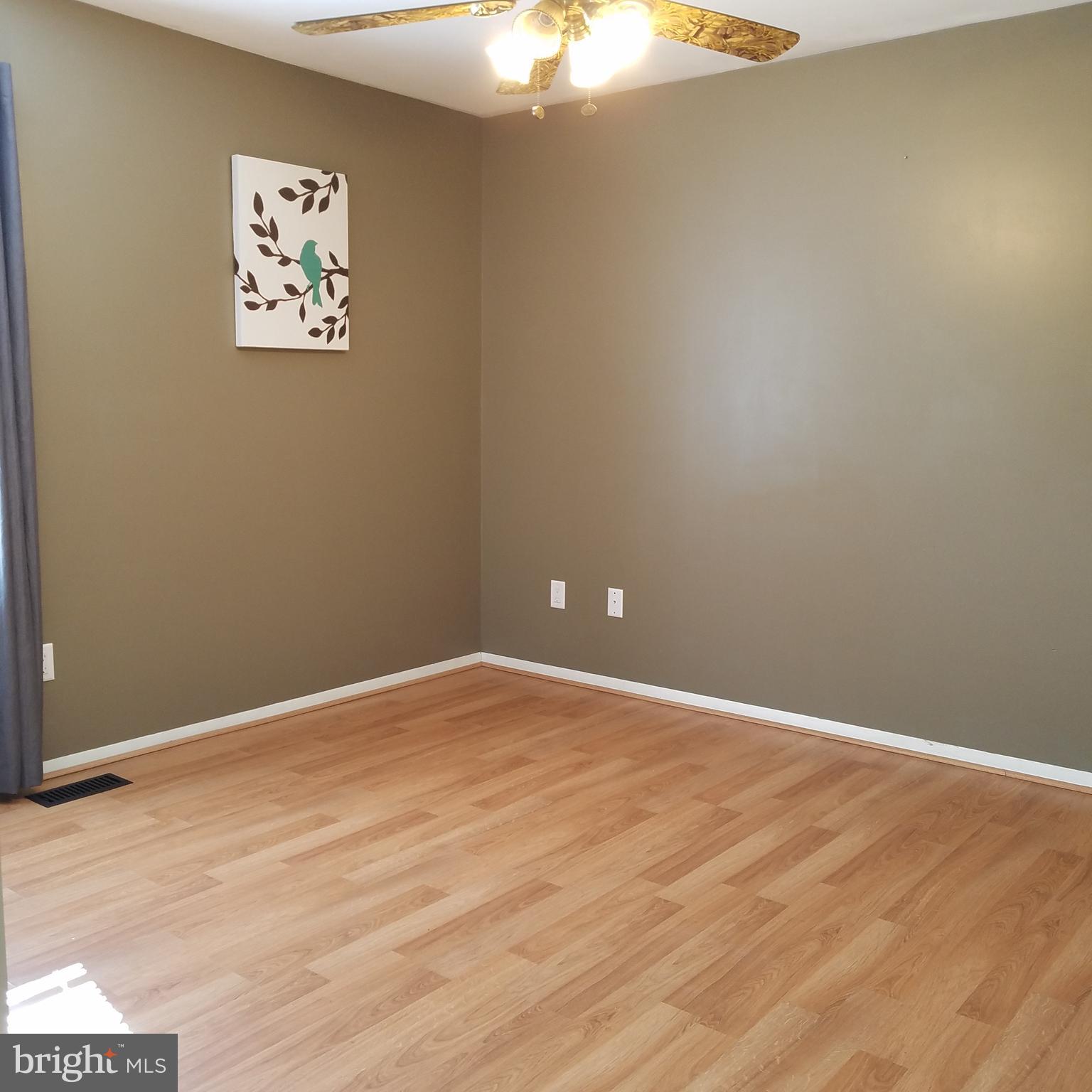5460 Bethlehem Road Preston, MD 21655 - Photo 14 of 25 en empty room with wooden floor and fan