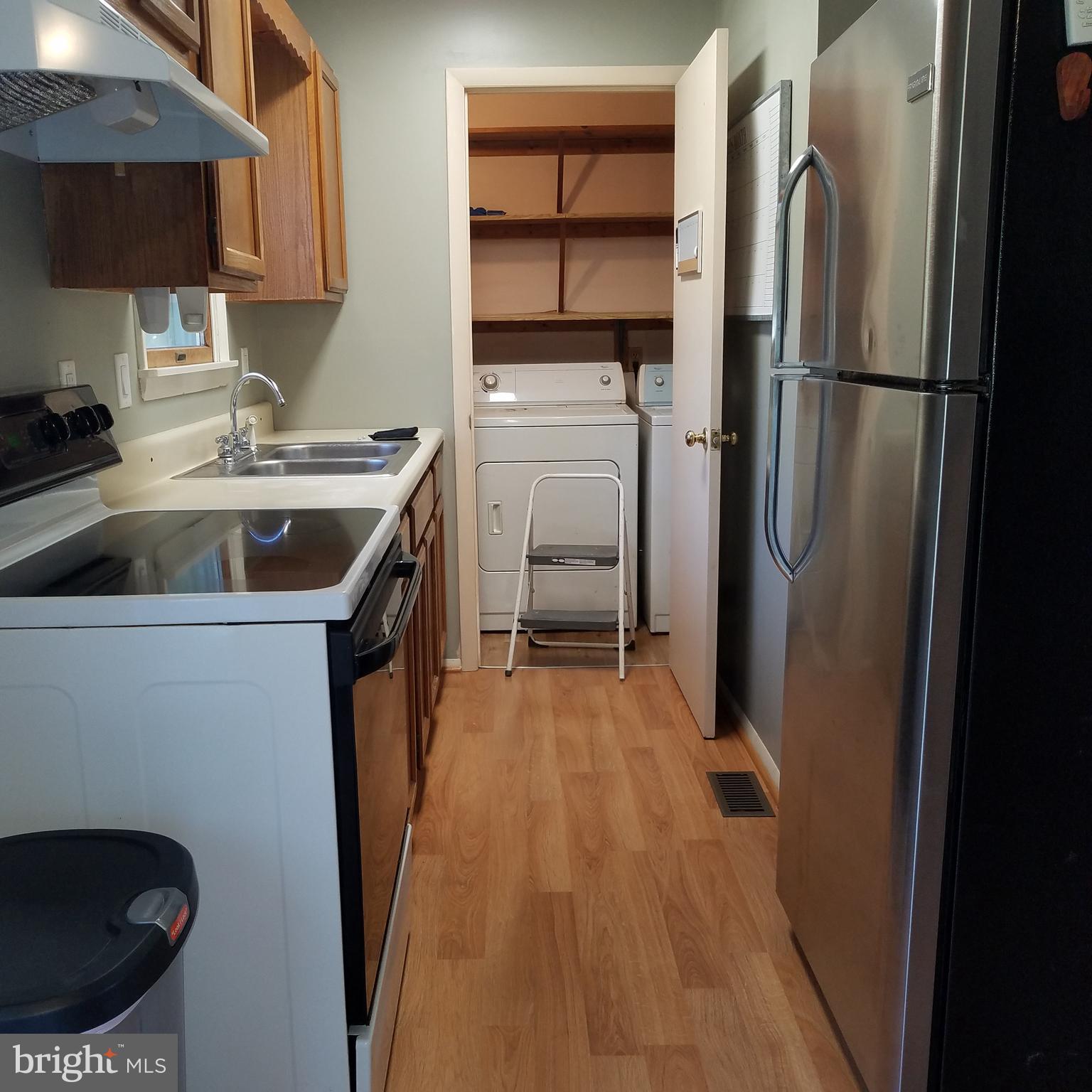 5460 Bethlehem Road Preston, MD 21655 - Photo 6 of 25 a kitchen with a refrigerator sink and cabinets