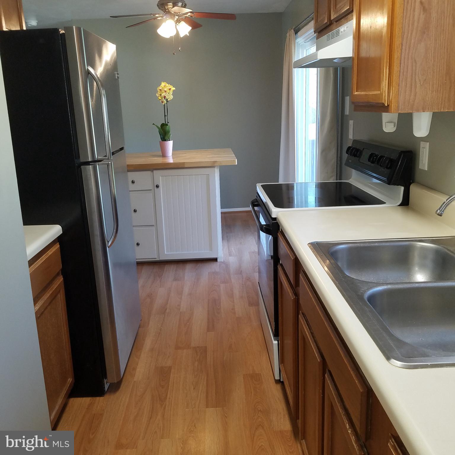 5460 Bethlehem Road Preston, MD 21655 - Photo 7 of 25 a kitchen with sink a refrigerator and a stove