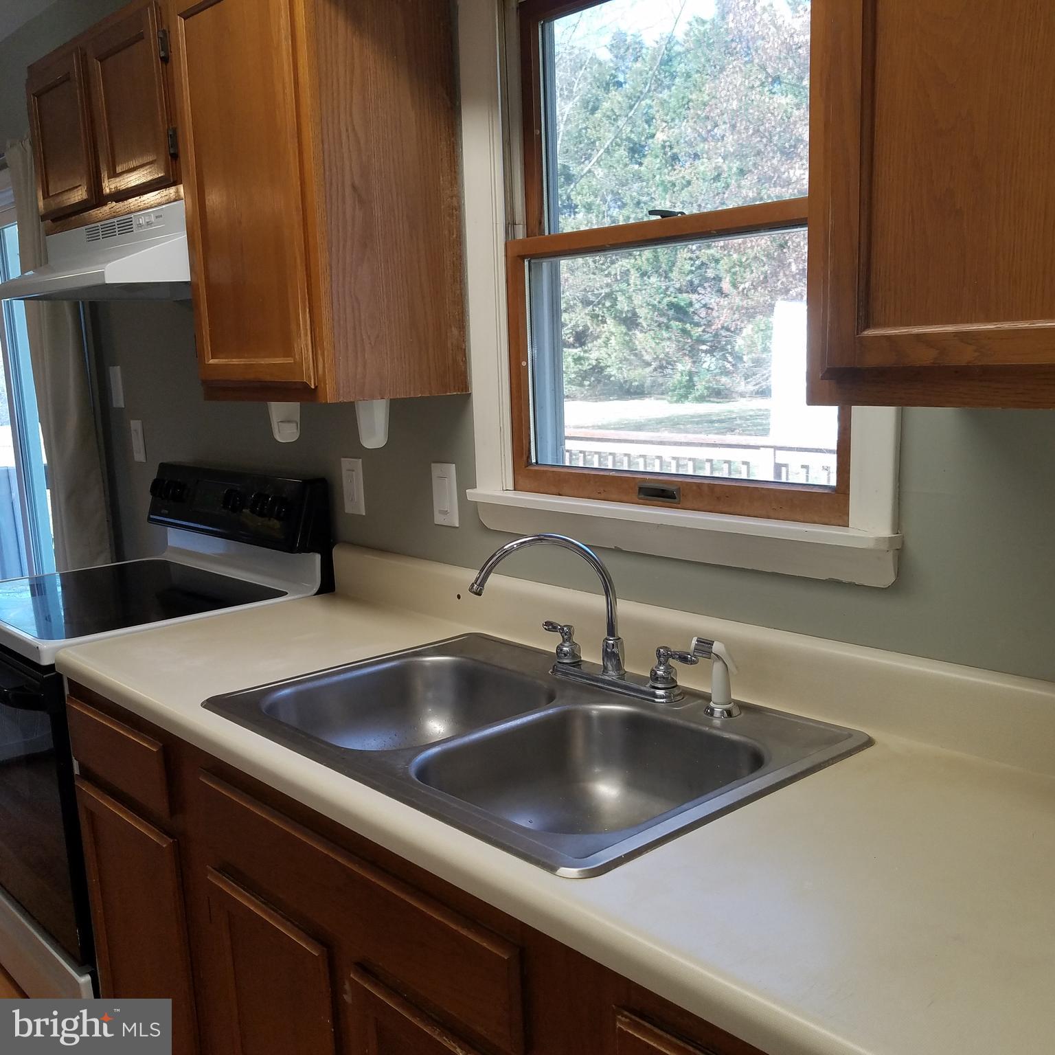 5460 Bethlehem Road Preston, MD 21655 - Photo 8 of 25 a kitchen with a sink cabinets and a window