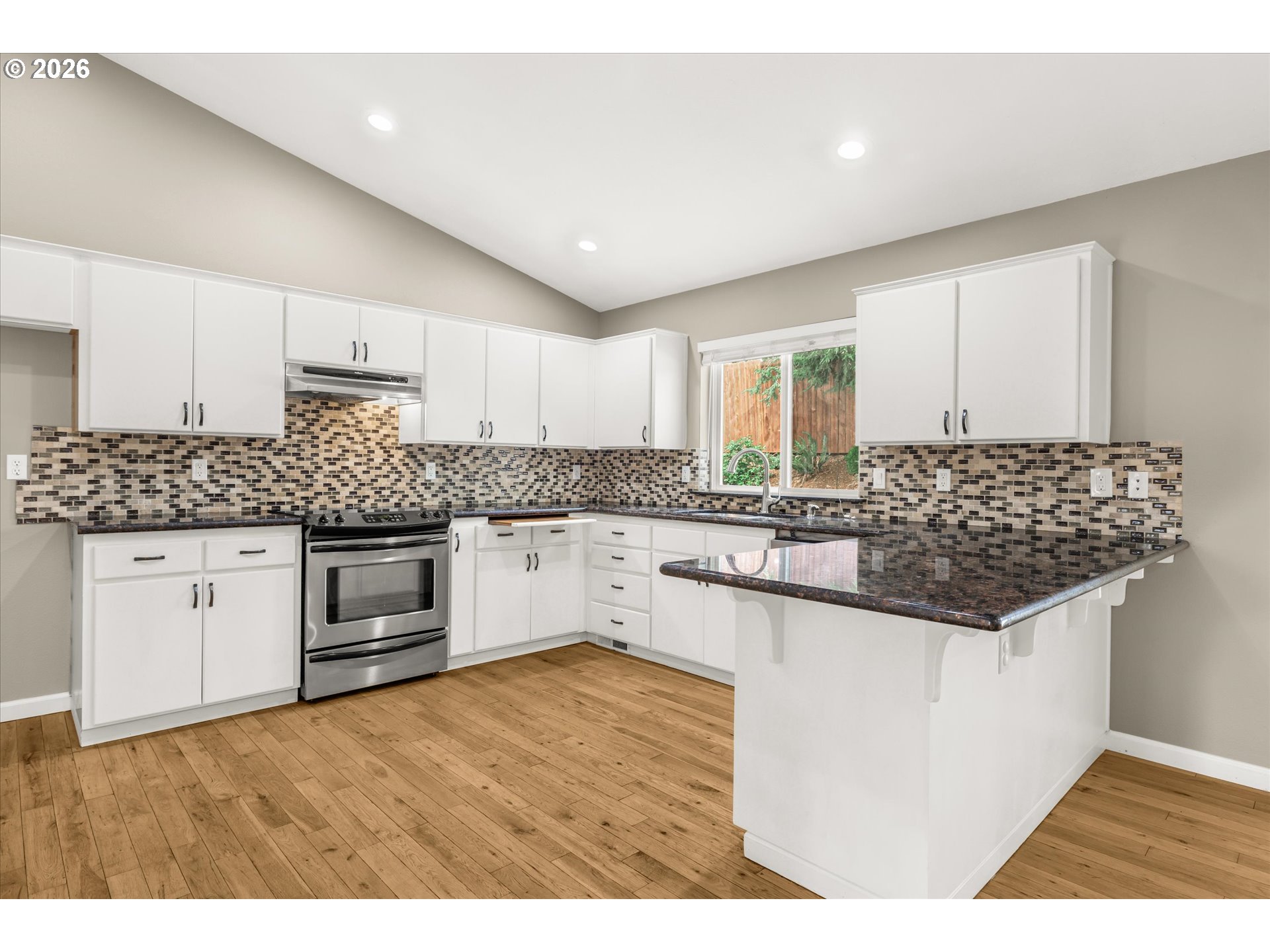 17200 Littlepage Avenue Sandy, OR 97055 - Photo 14 of 47 a kitchen with stainless steel appliances kitchen island granite countertop a sink and cabinets