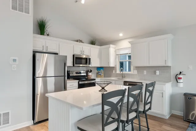 a kitchen with stainless steel appliances a refrigerator stove microwave and cabinets