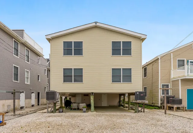 a front view of a house with a yard and seating space