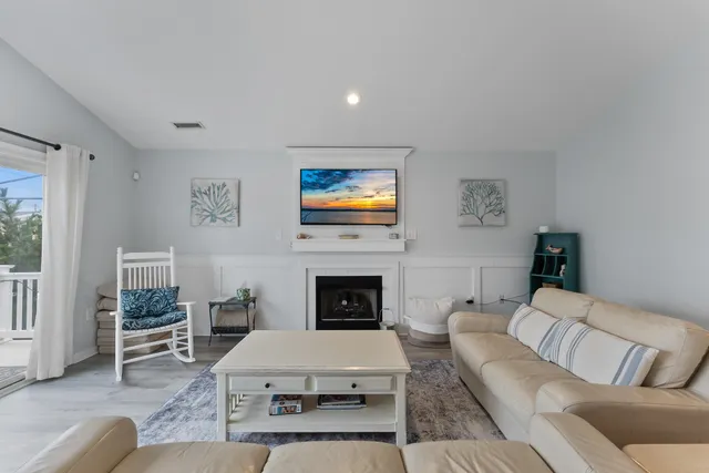a living room with furniture fireplace and window