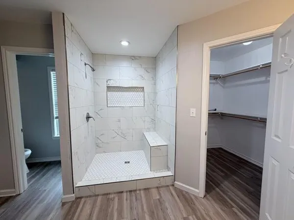 a bathroom with a tub and shower
