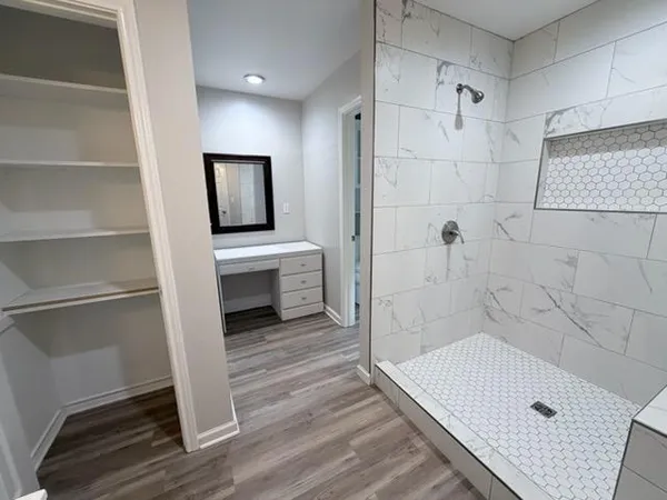 a bathroom with a tub and shower