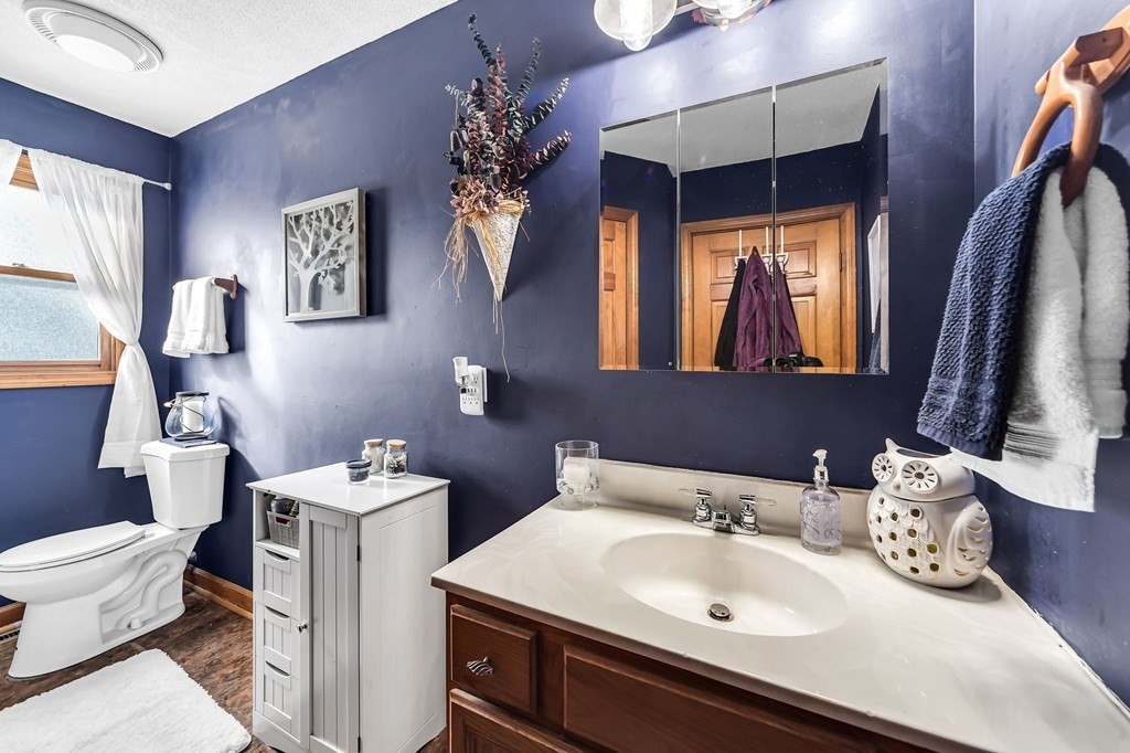 5 Pine Knoll Road Southwick, MA 01077 - Photo 18 of 40 a bathroom with a toilet sink and mirror