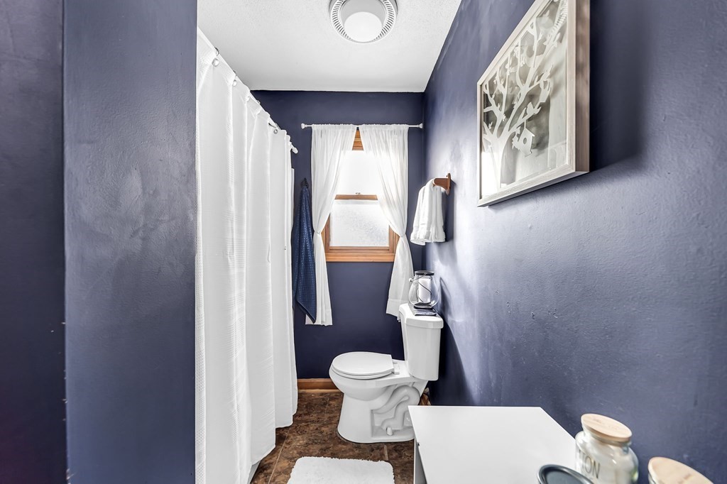 5 Pine Knoll Road Southwick, MA 01077 - Photo 19 of 40 a bathroom with a toilet and a shower curtain