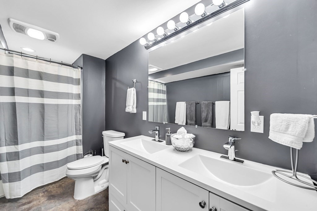 5 Pine Knoll Road Southwick, MA 01077 - Photo 34 of 40 a bathroom with a double vanity sink toilet and a mirror