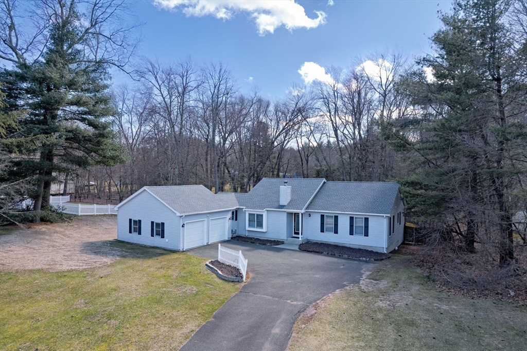 5 Pine Knoll Road Southwick, MA 01077 - Photo 36 of 40 a front view of a house with a yard and large trees
