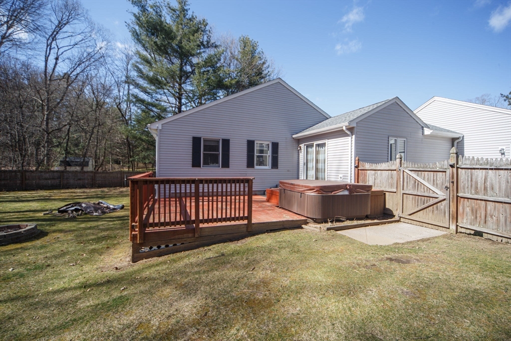 5 Pine Knoll Road Southwick, MA 01077 - Photo 37 of 40 a view of a house with a wooden deck and a yard