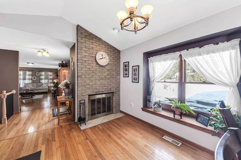 5 Pine Knoll Road Southwick, MA 01077 - Photo 8 of 40 an empty room with wooden floor fireplace and windows