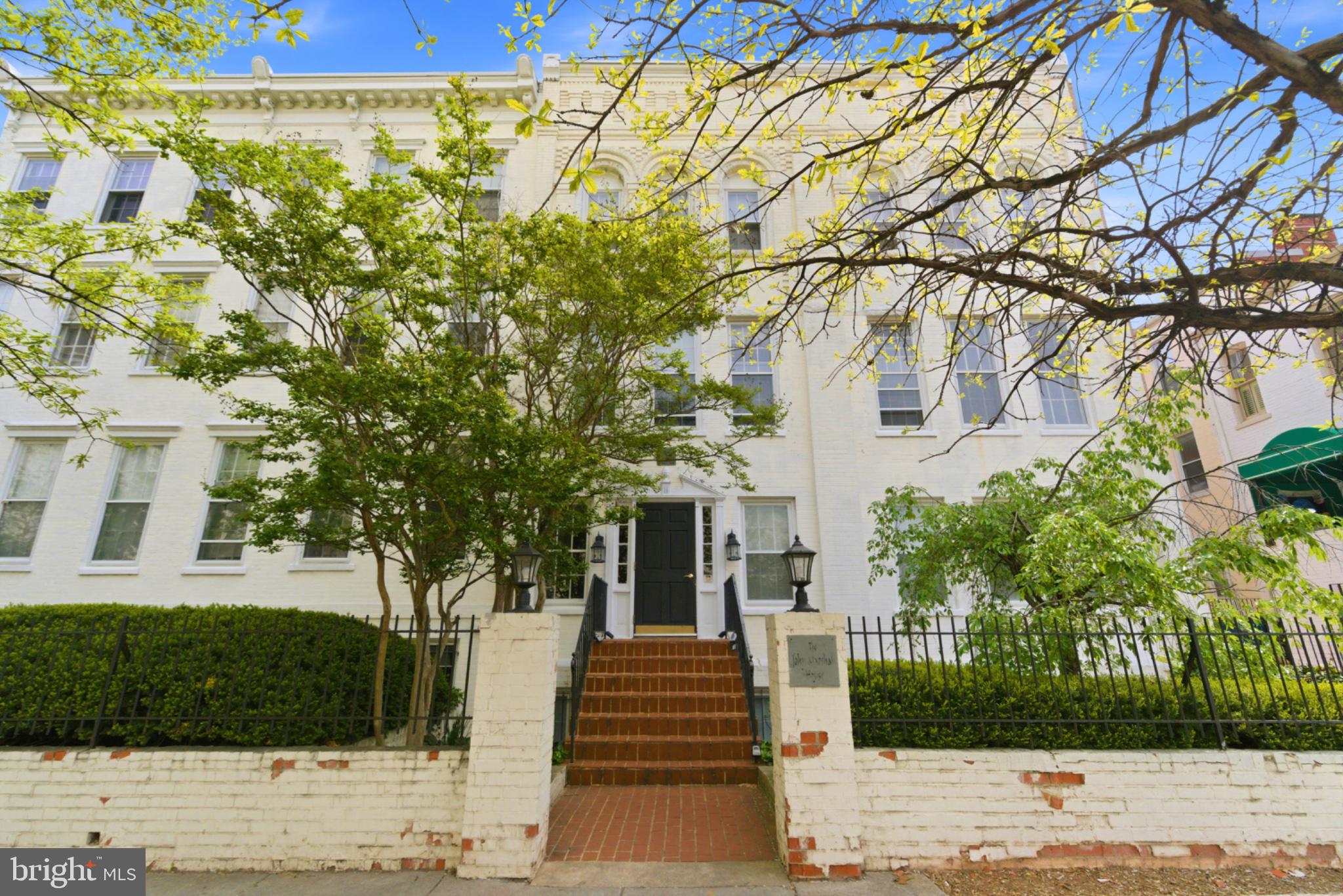Charming historic residence with greenery.