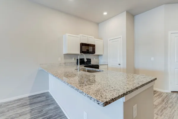a kitchen with granite countertop a sink and a granite counter top