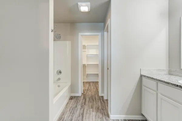 a view of hallway with wooden floor