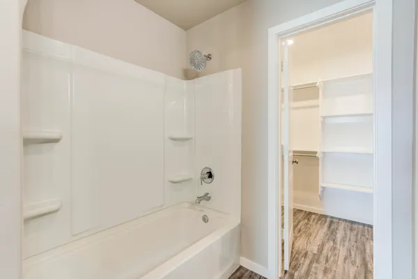 a bathroom with a bathtub and a shower