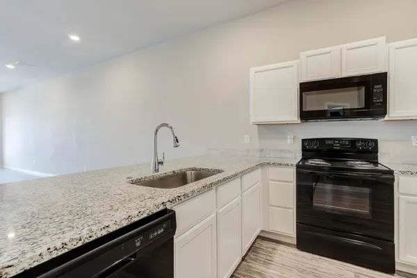 a kitchen with a sink and steel appliances