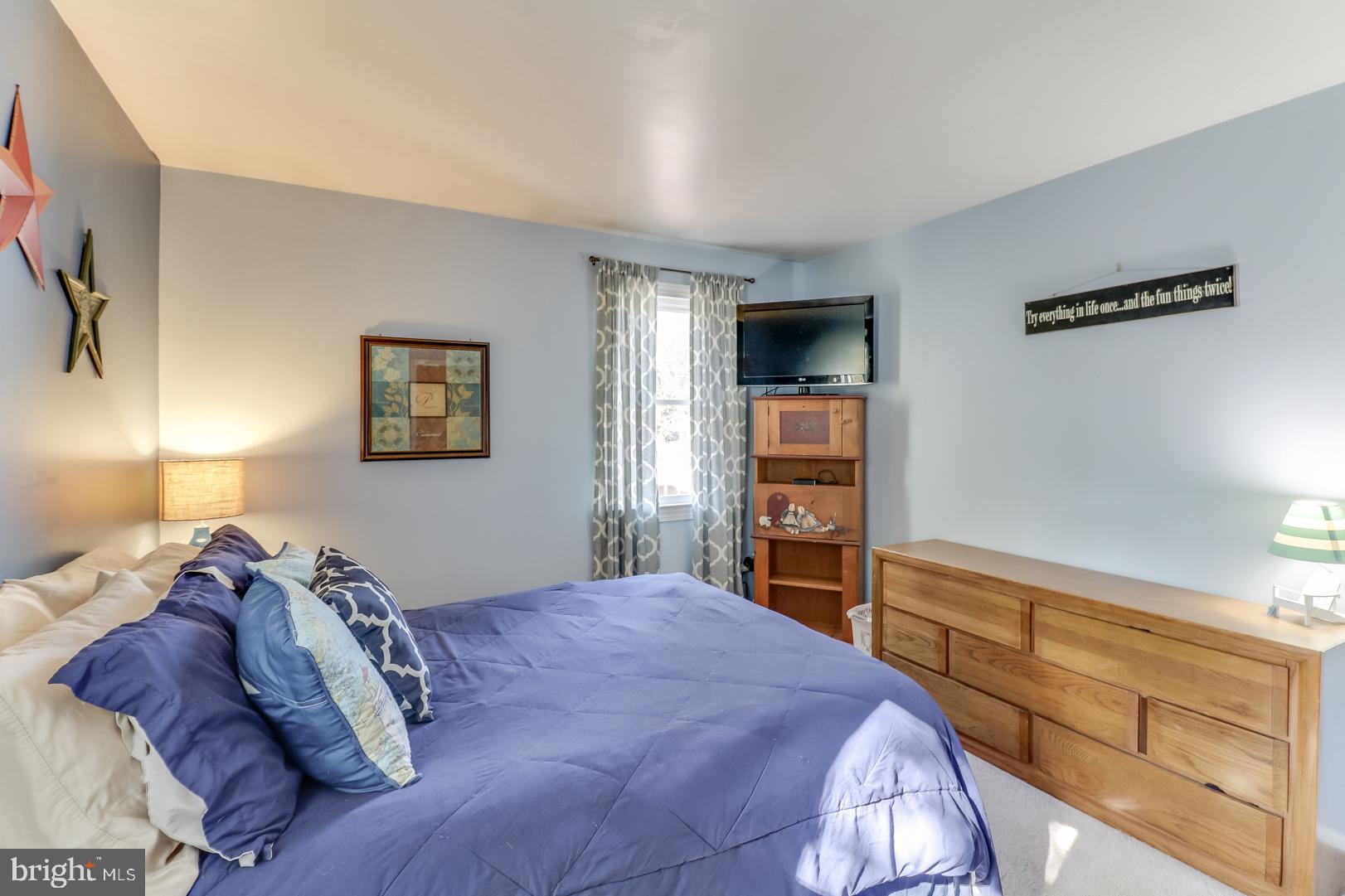 306 South Brownleaf Road Newark, DE 19713 - Photo 12 of 30 a bedroom with a bed and a flat tv screen on the dresser