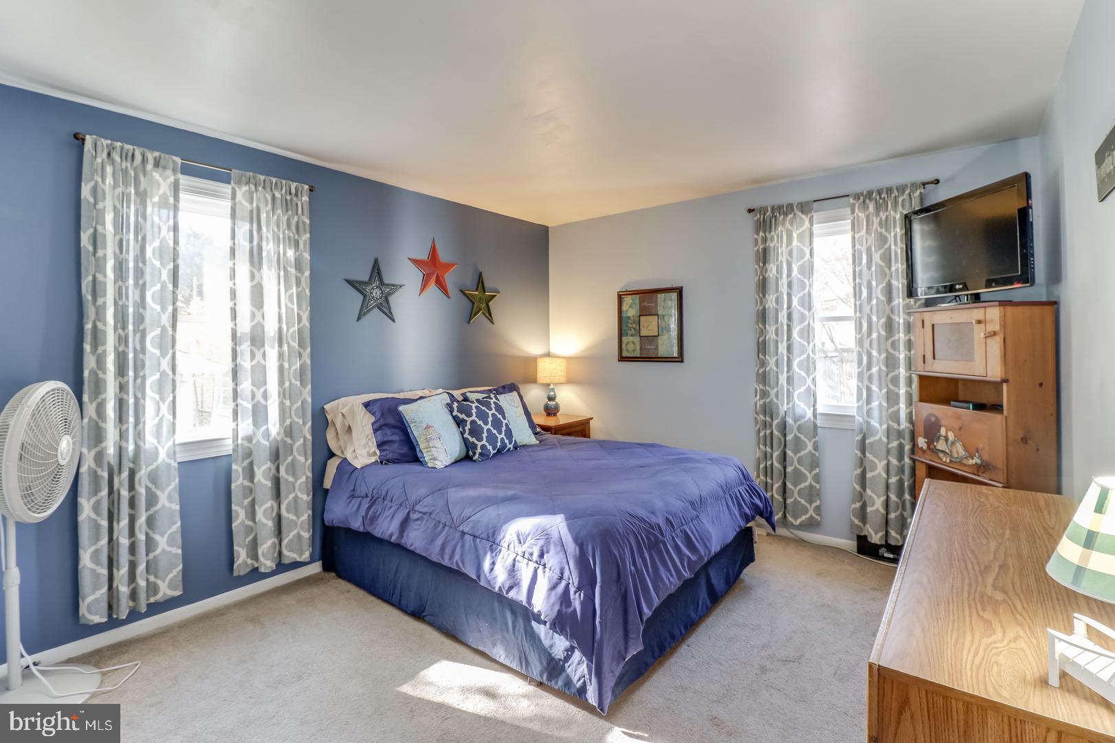306 South Brownleaf Road Newark, DE 19713 - Photo 13 of 30 a bedroom with a large bed a flat tv screen and a dresser