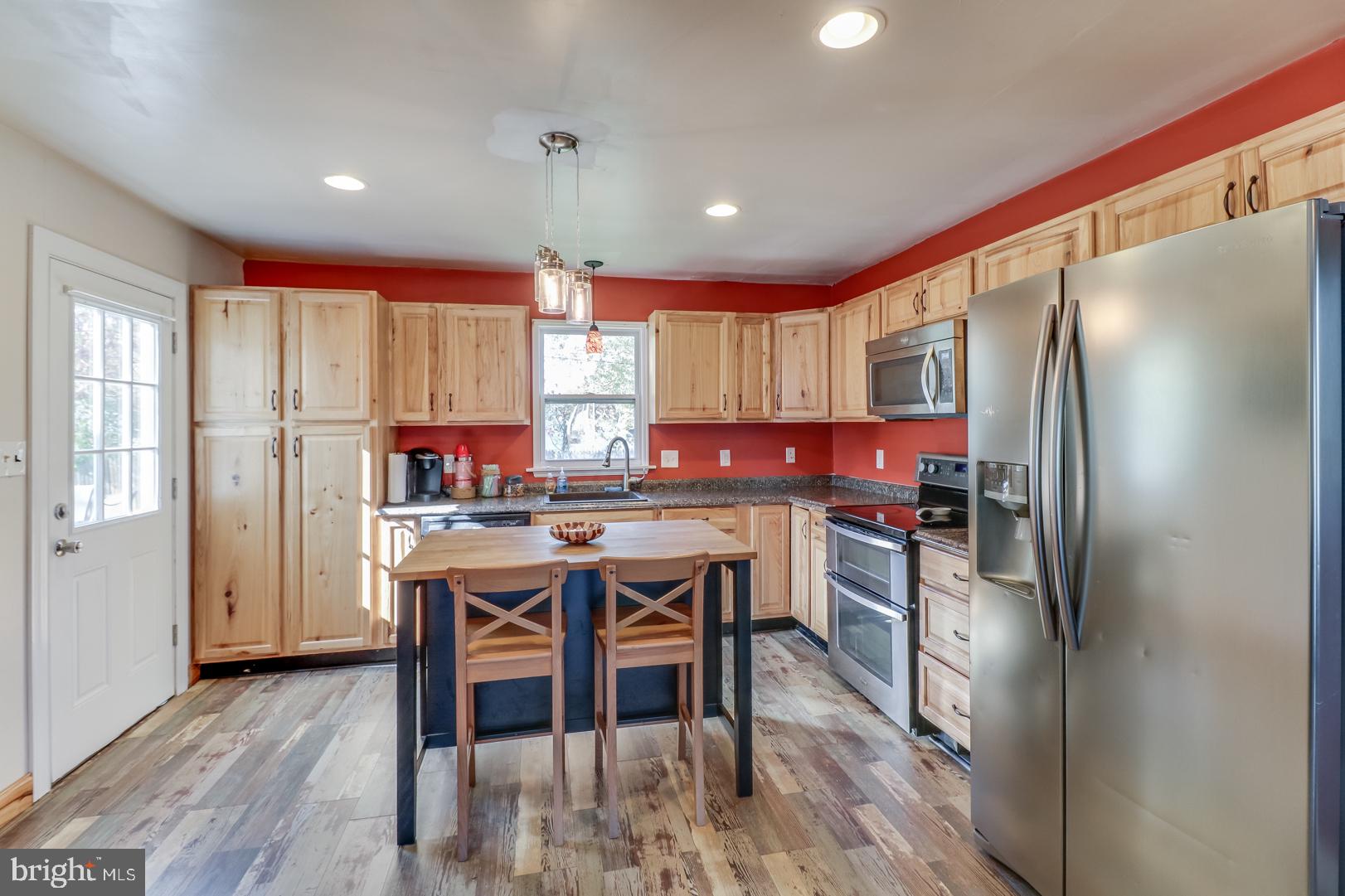 306 South Brownleaf Road Newark, DE 19713 - Photo 8 of 30 a kitchen with stainless steel appliances granite countertop a refrigerator a sink dishwasher a stove and white cabinets with wooden floor