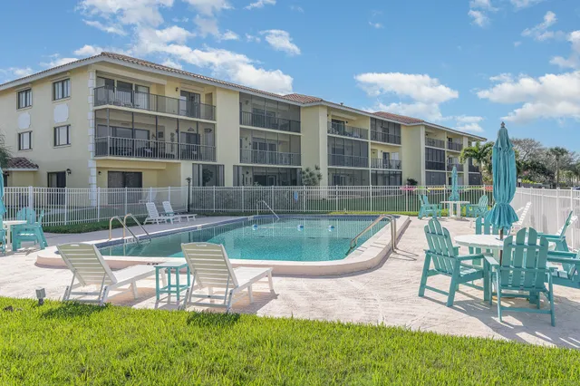 a view of a house with a yard table and chairs