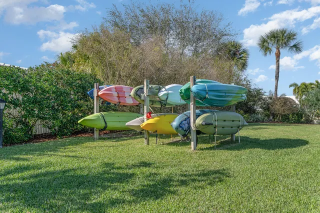a view of a backyard with plants and chairs