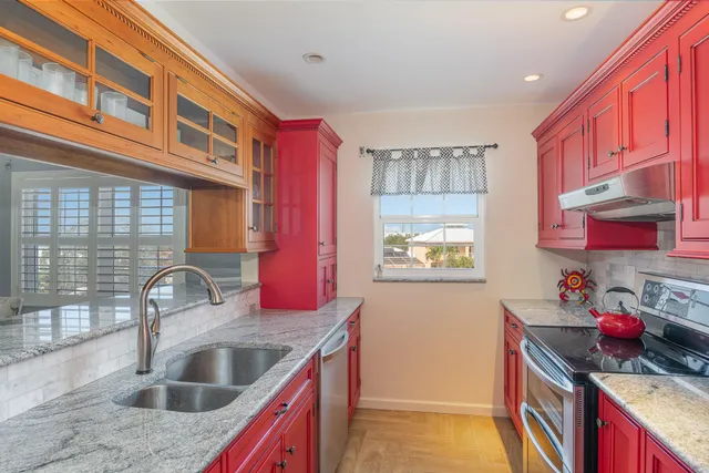 a kitchen with a sink stove and cabinets