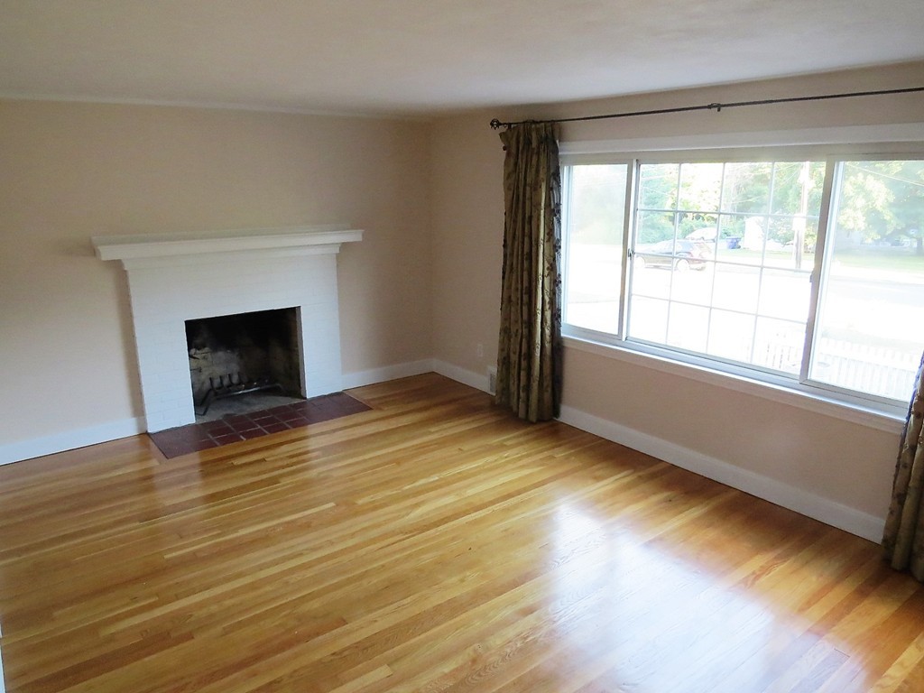 64 Oak Hollow Road Springfield, MA 01128 - Photo 3 of 22 a view of empty room with wooden floor and fireplace