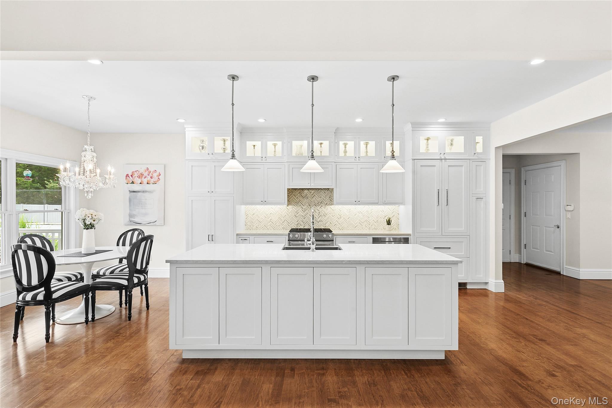 3470 North Bayview Road Southold, NY 11971 - Photo 3 of 25 Kitchen with white cabinets, tasteful backsplash, decorative light fixtures, wood finished floors, and recessed lighting