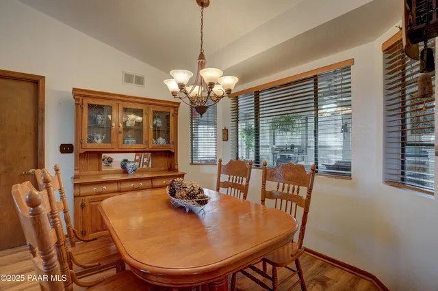 a view of a dining room with furniture wooden floor and chandelier