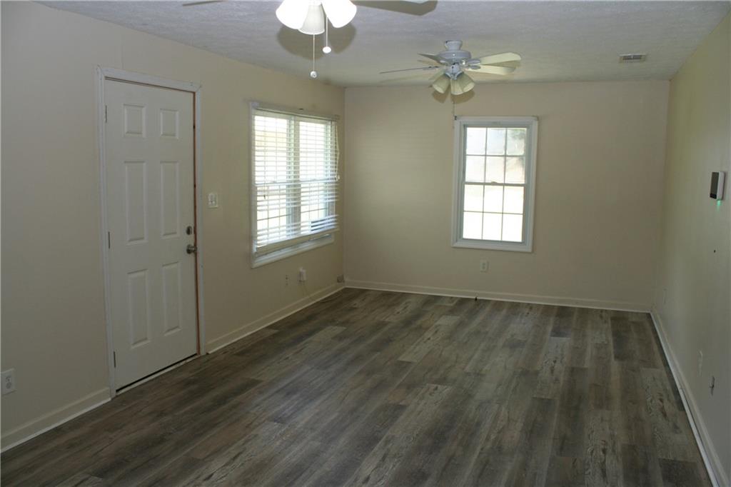3735 South Seale Road Phenix City, AL 36869 - Photo 17 of 27 Living Room with a ceiling fan, LVP style flooring, and a textured ceiling