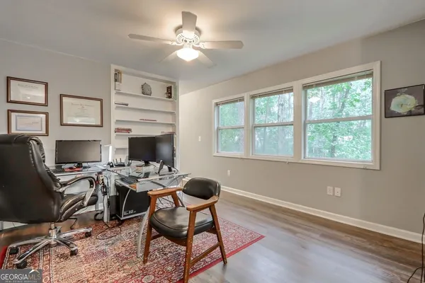 a view of a workspace with furniture and a window