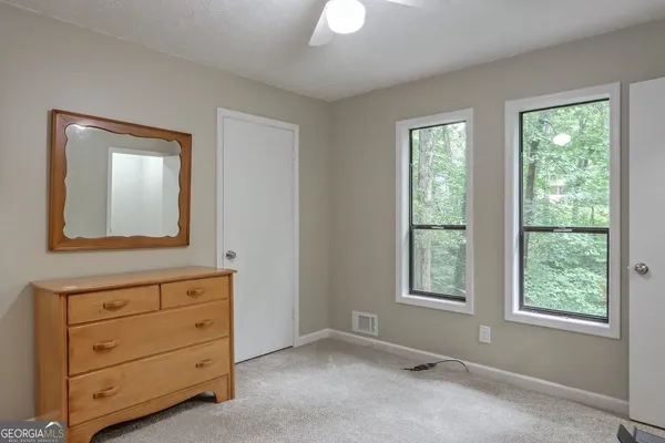 a view of room with window and cabinet