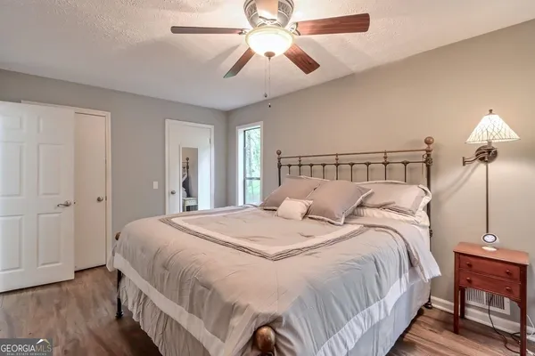 a bedroom with bed and a chandelier