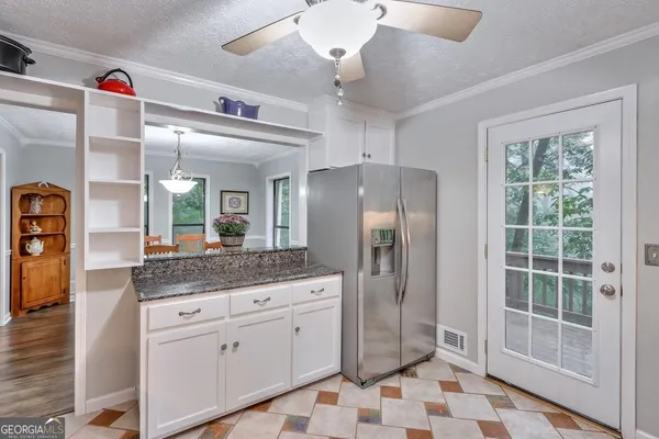 a spacious bathroom with a granite countertop sink a mirror and a shower