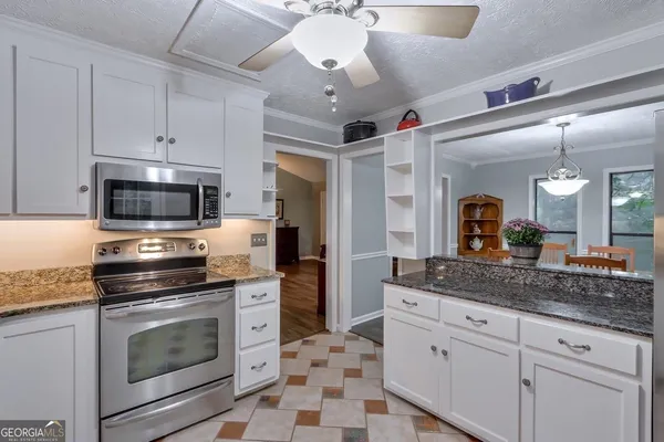 a kitchen with stainless steel appliances granite countertop a stove and a sink