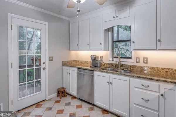 a kitchen with a sink window and cabinets