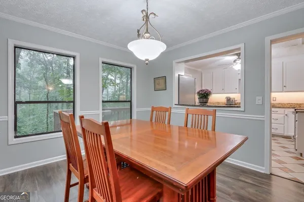 a dining room with furniture window and wooden floor