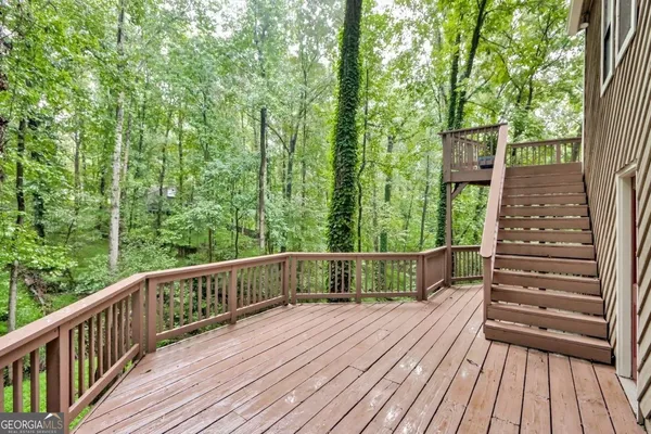 a view of balcony with wooden floor and fence