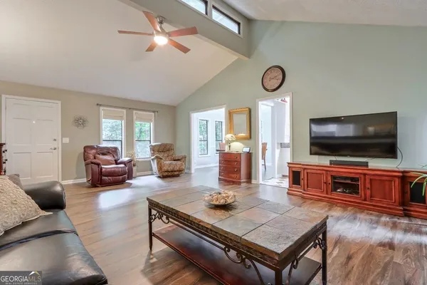 a living room with furniture and a flat screen tv