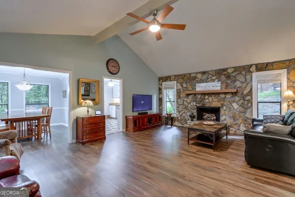 a living room with furniture a fireplace and a flat screen tv