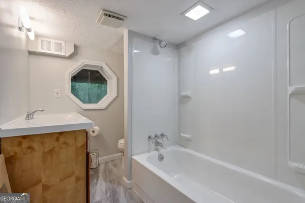 a bathroom with a sink a bathtub and a shower