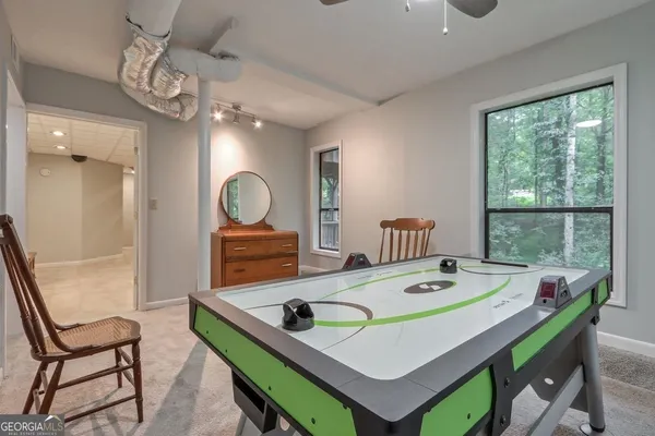 a view of a dining room with a table and chairs