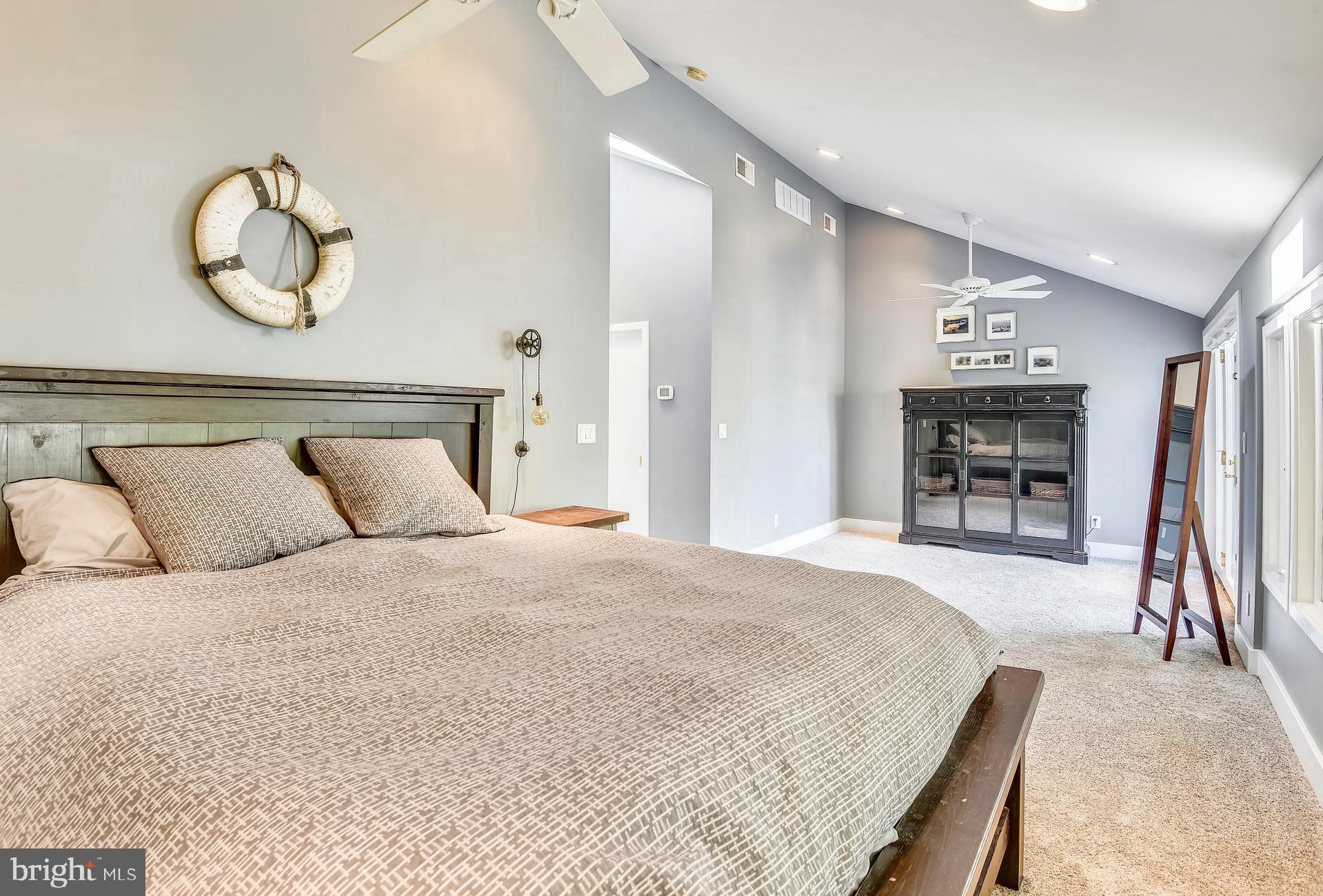 137 Inverness Road Severna Park, MD 21146 - Photo 32 of 46 a spacious bedroom with a bed and a chandelier
