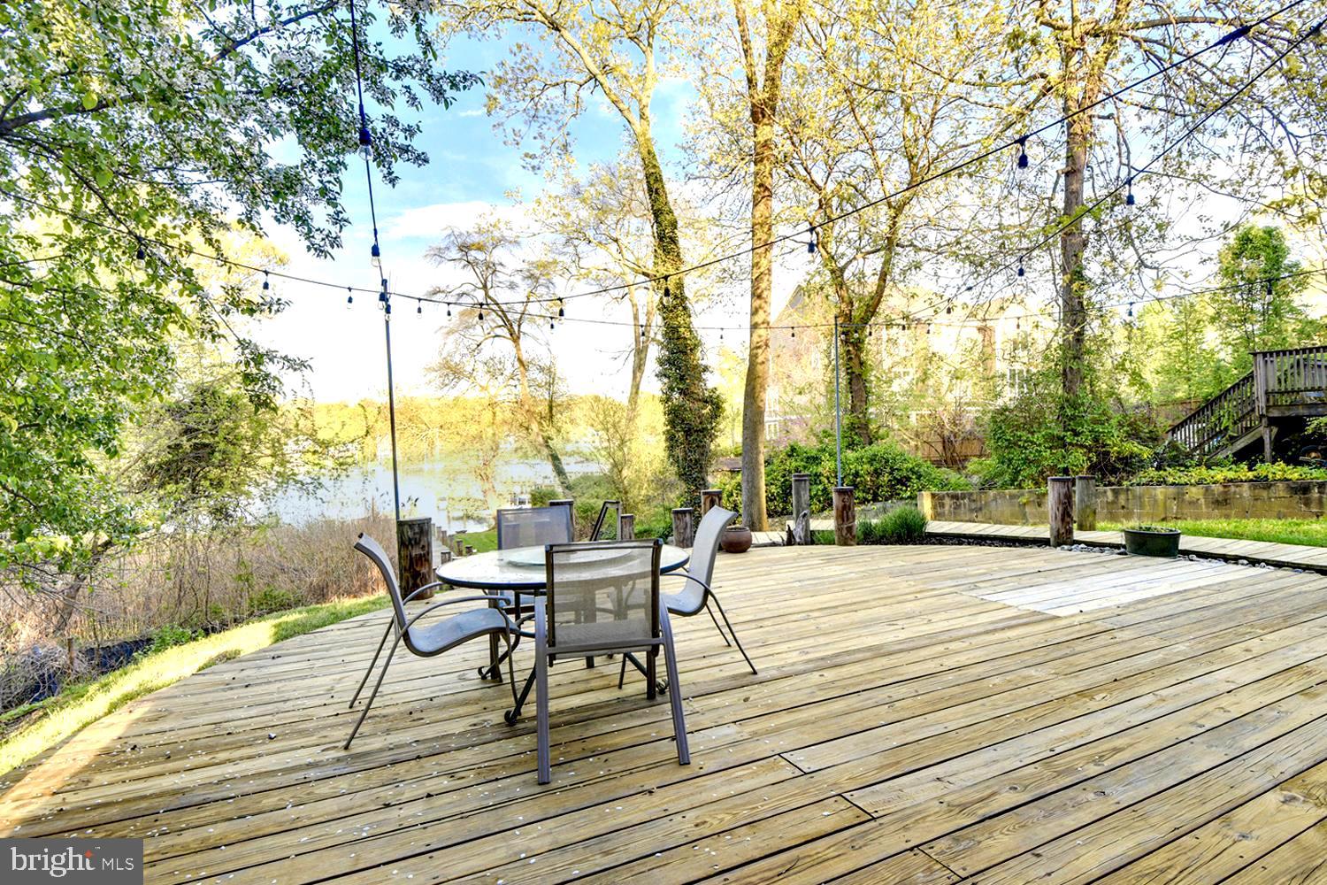 137 Inverness Road Severna Park, MD 21146 - Photo 43 of 46 a view of a patio with table and chairs with wooden floor and fence